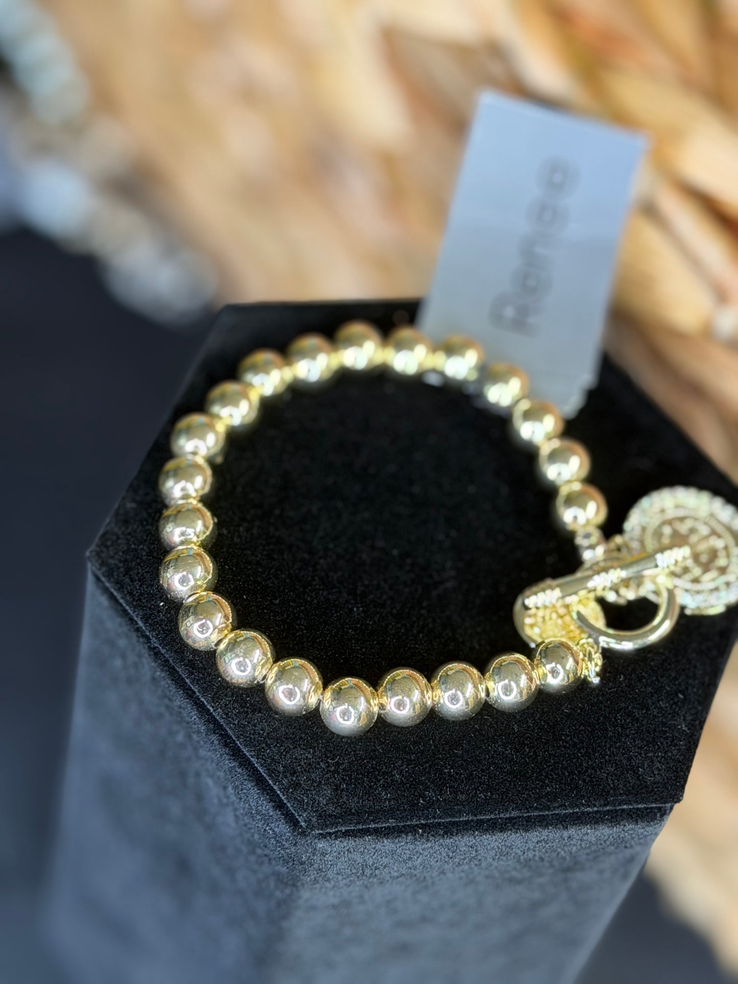 Gold beaded bracelet with charms