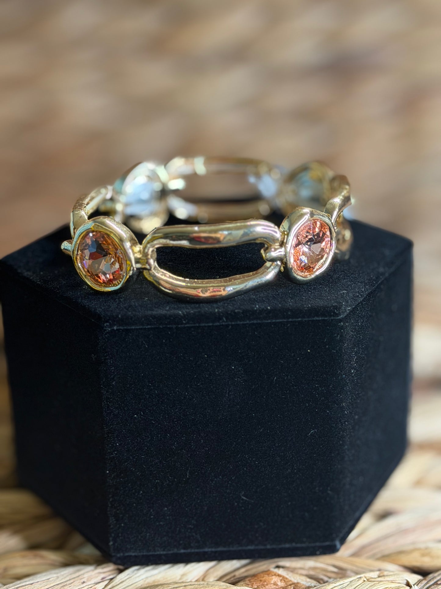 Gold stretchy bracelet with orange stone