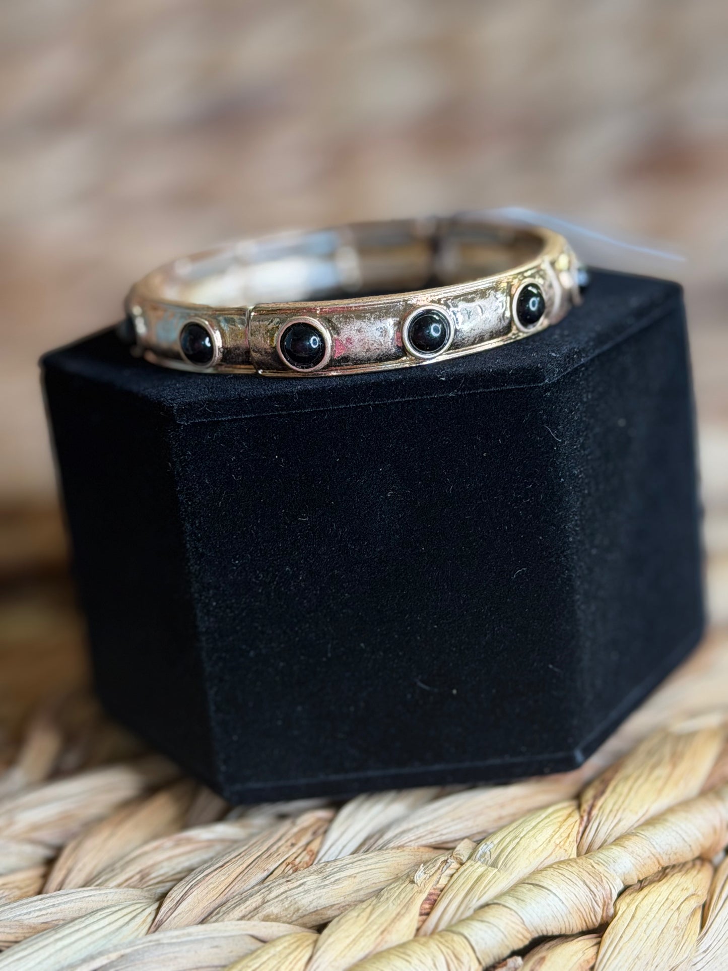 Stretchy gold bracelet with black stones