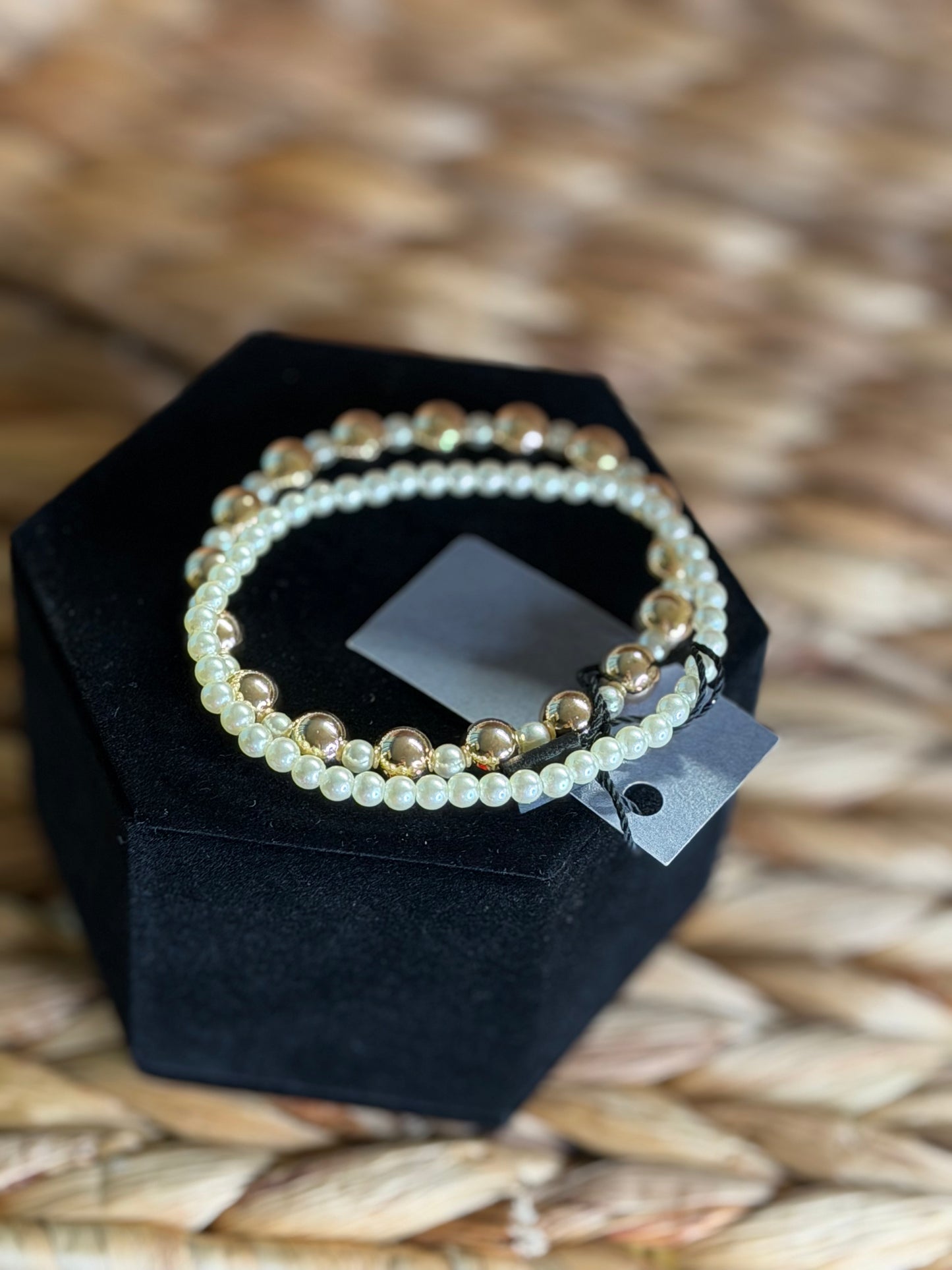 Stretchy bracelets with gold beads and pearls.