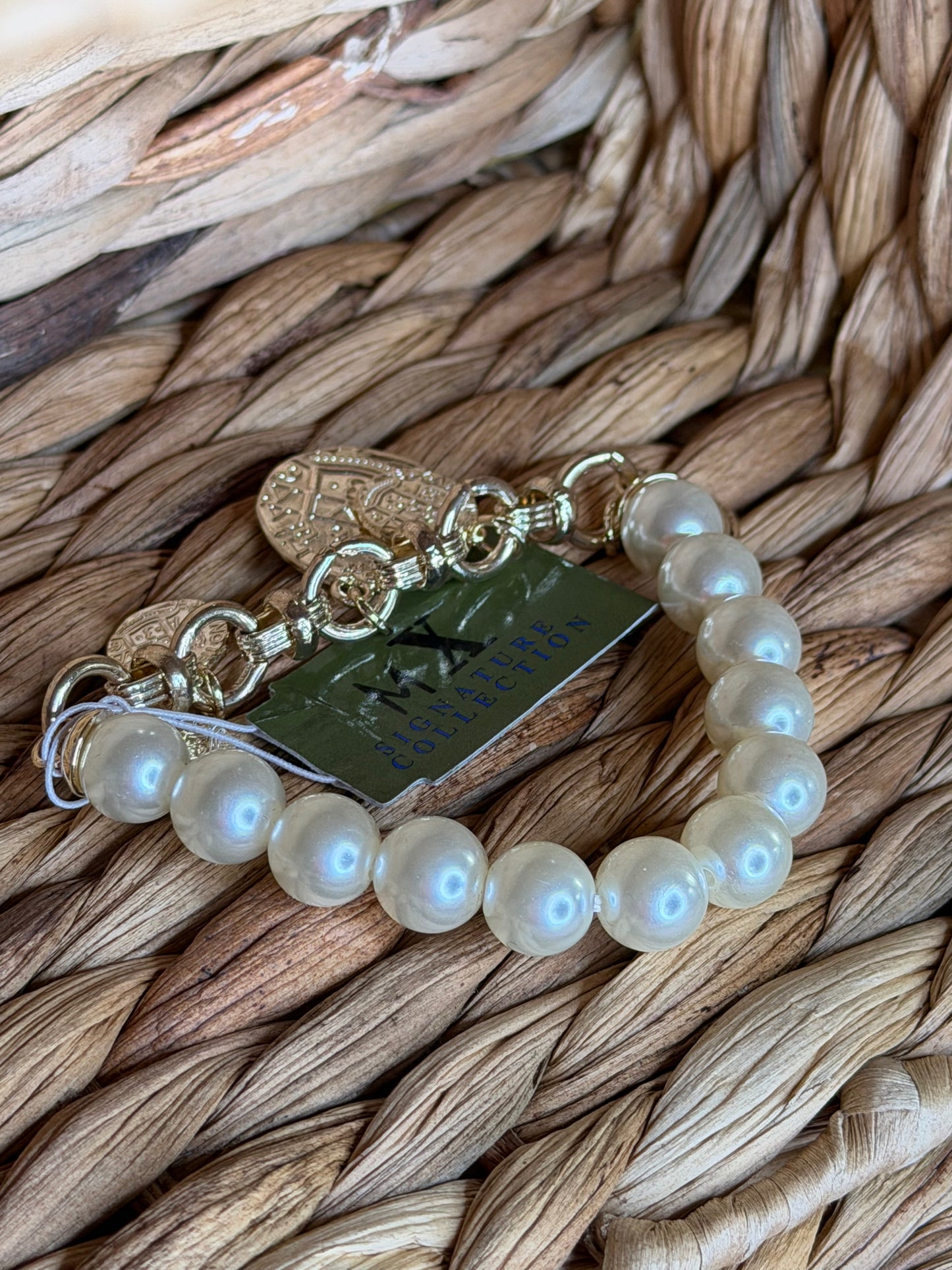 Gold bracelet with pearls and charms