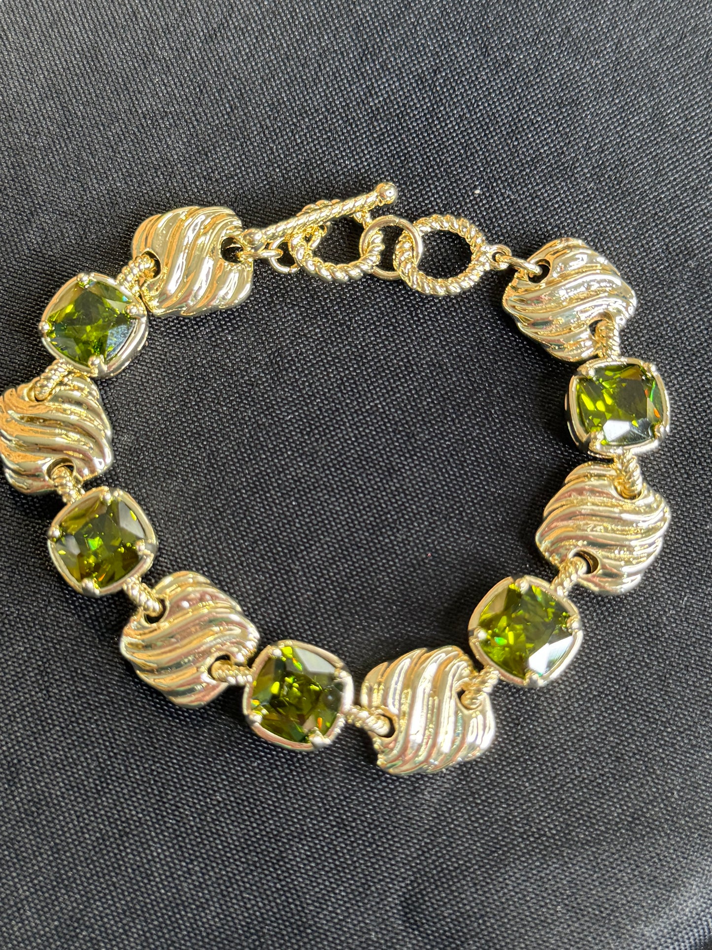 Gold bracelet with square olive green stones