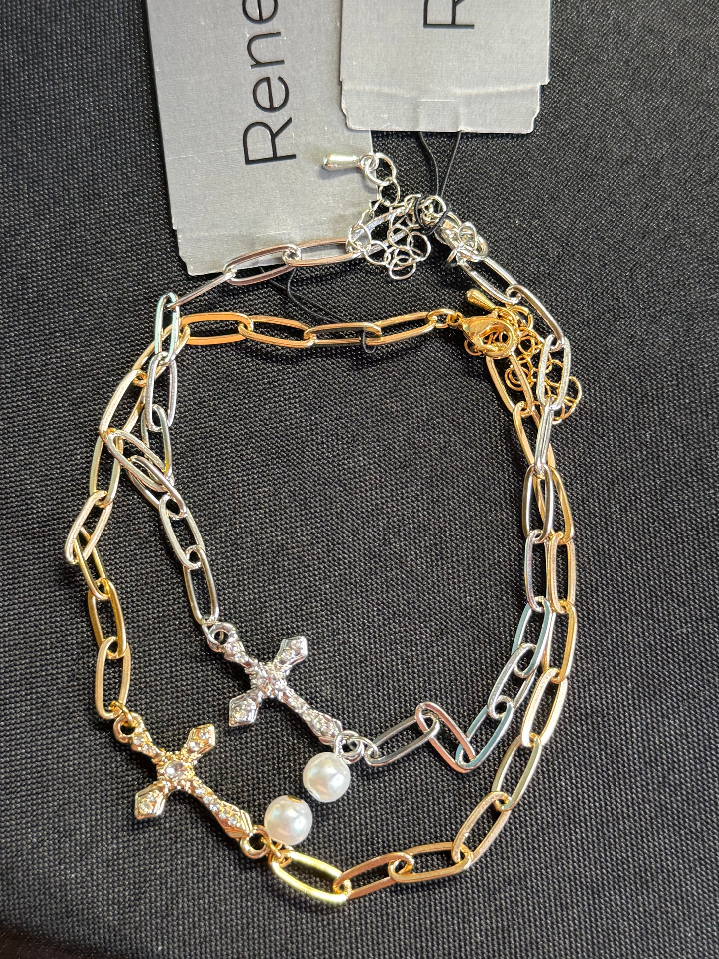 Gold and silver paperclip bracelets with cross and pearl