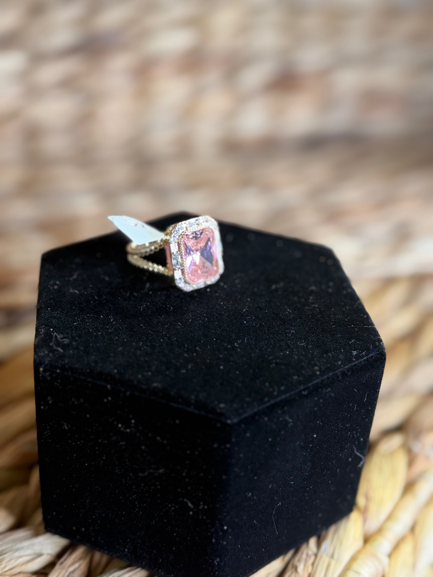 Gold ring with pink stone and surrounding diamonds