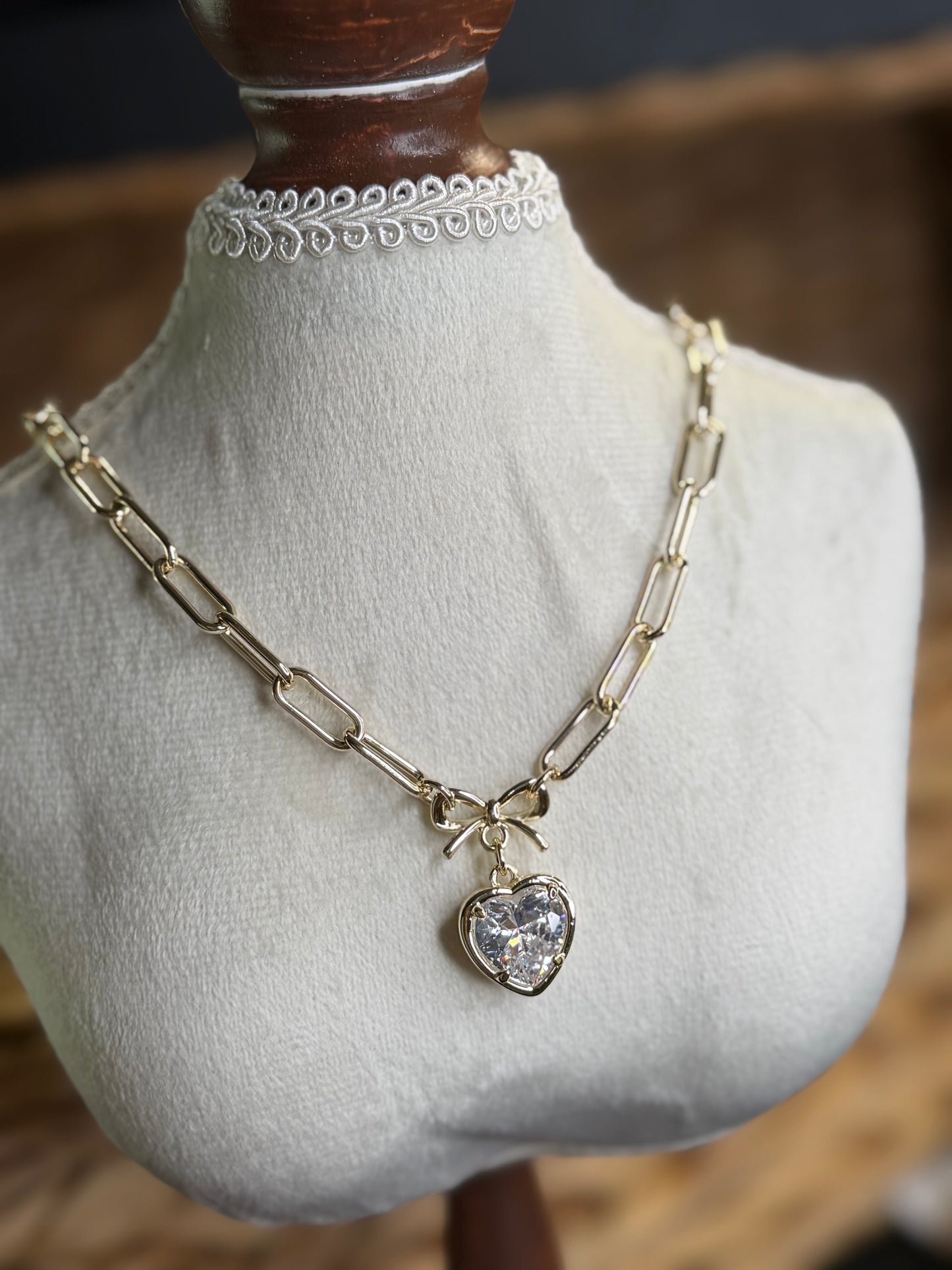 Gold paperclip necklace with CZ heart and bow