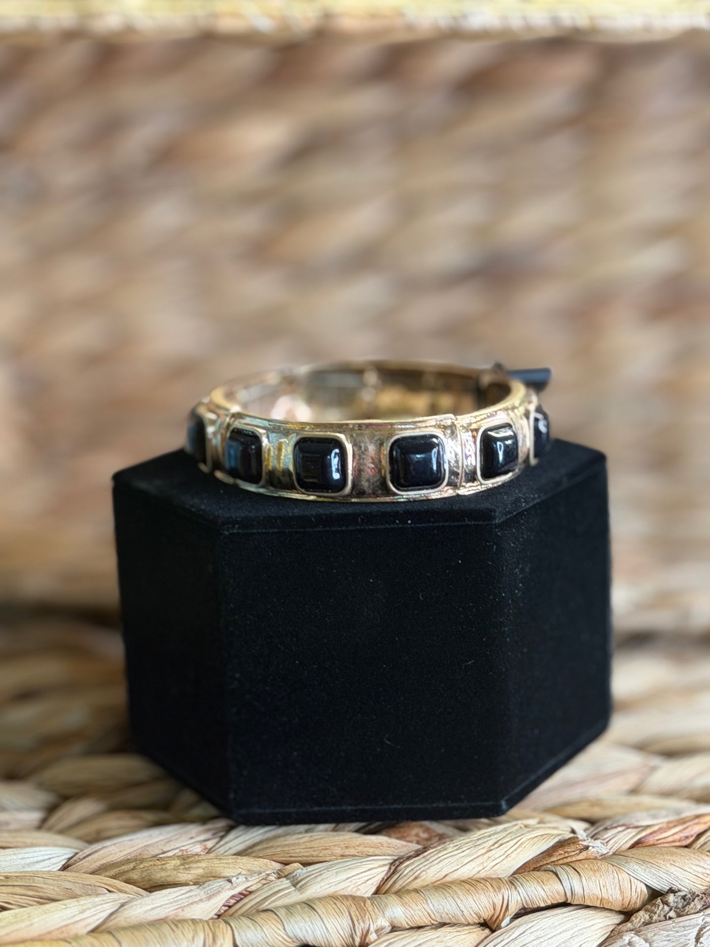 Stretchy gold bracelet with black stones