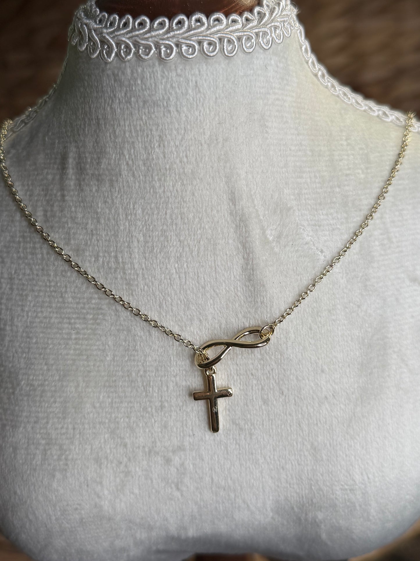 Gold necklace with cross and infinity sign
